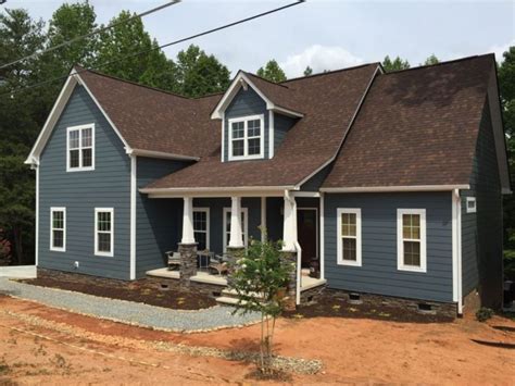 gray house with brown metal roof|dark brown house siding.